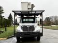 A 2020 International MV607 truck with an elevated cherry picker platform mounted on top