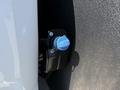 A close-up of a blue fuel cap on a 2023 Ford F-550 mounted on a black surface