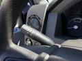 The image shows the turn signal lever of a 2014 Ford F-250 SD with various controls and a speedometer in the background