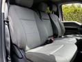 The interior of a 2020 Ford F-350 Super Duty featuring a row of gray fabric seats with headrests and seatbelts