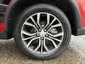 Close-up of a silver alloy wheel on a 2016 Mitsubishi Outlander with a Yokohama tire showing intricate spoke design and brake components visible through the spokes