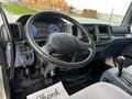 Interior view of a 2006 Hino 268 cab featuring a steering wheel dashboard with gauges and controls visible along with a gear shift and floor mat displaying the word Thank