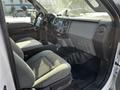 Interior of a 2011 Ford F-450 SD featuring gray seats a dashboard with controls and a black floor mat