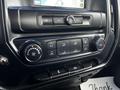 Dashboard controls of a 2017 GMC Sierra 1500 featuring climate control knobs and button panel for air conditioning and temperature settings