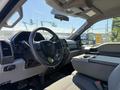 Interior of a 2017 Ford F-350 SD featuring a steering wheel dashboard and center console with storage space