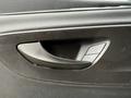 A close-up view of the door handle and window control panel of a 2019 Mercedes-Benz Sprinter