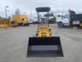 A 2024 AGT KRW 23 Mini loader with a front bucket attachment facing forward