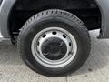 A close-up of a silver wheel and tire from a 2018 Ford Transit showing the rim design and tread pattern
