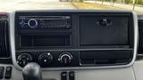 Dashboard of a 2018 Mitsubishi Fuso FE featuring a radio, various knobs for climate control, and empty slots for additional equipment