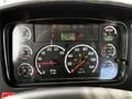 Dashboard of a 2012 Freightliner M2 106 showing gauges for speed RPM oil water and air pressure with a digital display indicating mileage and other metrics