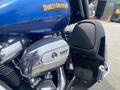 Close-up of a 2017 Harley-Davidson FLHTKL engine with chrome detailing featuring a 107 badge and footrest in black leather