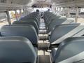 Interior of a 2007 Blue Bird Vision school bus featuring rows of gray seats arranged in a symmetrical layout with aisle down the center