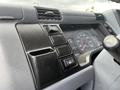 The dashboard of a 2008 Mitsubishi Fuso FE180 featuring various control buttons and a speedometer display