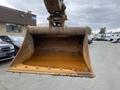 A 2012 John Deere 310SJ excavator bucket is shown in an elevated position with a rusty interior and slight wear on the edges