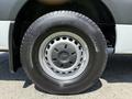 Close-up of a wheel and tire from a 2019 Mercedes-Benz Sprinter showcasing a silver rim and textured black tire with visible tread patterns