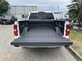 A 2016 GMC Sierra 1500 pickup truck with an open bed revealing a rubber liner and the GMC logo on the tailgate