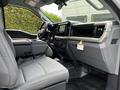 Interior view of a 2024 Ford F-550 showing the driver's seat and dashboard with modern controls and a sleek design