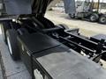 A 2017 International WorkStar 7600 truck with a black body and prominent tires is shown from a high angle, highlighting its cargo area and equipment storage compartments