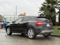 A 2016 Mercedes-Benz GLA-250 in black parked, showcasing its sleek design, alloy wheels, and streamlined rear with visible branding on the back hatch