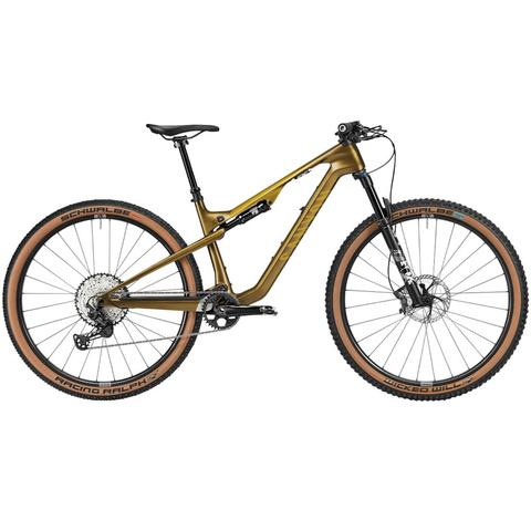A 2025 Canyon Lux Trail CF 8 mountain bike featuring a gold frame black handlebars and two large wheels with brown tires