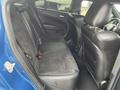 Interior view of the back seat of a 2022 Dodge Charger featuring dark upholstery and a sleek design with ample space and comfortable seating