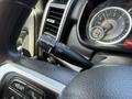 A close-up of the steering wheel and control stalk of a 2020 Ram 2500 showcasing the wiper and turn signal controls along with part of the dashboard and speedometer
