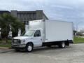 A white 2022 Ford E-450 box truck parked on a gravel surface with a plain storage compartment and front cab design