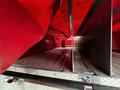 Interior of a 1991 Sutphen Deluge fire truck showing a metal floor and storage compartments with red fabric and walls