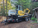 A 2024 Southland SL716-20K trailer with a yellow Komatsu mini excavator on top showcasing tracks and a digging arm
