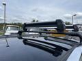 A 2015 Kia Sorento with a roof rack mounted on top