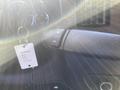 A close-up of a 2012 GMC Savana dashboard featuring a steering wheel control and a key tag attached to the ignition
