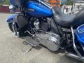 Blue 2017 Harley-Davidson FLHTKL motorcycle with chrome engine components and black leather seat