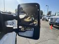 A side mirror of a 2014 Ford F-350 SD reflecting the interior and exterior with clear visibility of the mirror frame and glass
