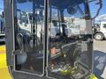 A 2010 Kubota F3990 featuring a steering wheel and controls visible through the cab's clear glass window