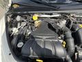 The engine of a 2005 Chrysler PT Cruiser featuring a 24L turbocharged system with various components and hoses visible