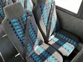 Interior seating of a 2022 Blue Bird BB Conventional bus featuring grey fabric with blue and black patterns and seatbelts