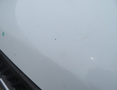 A 2020 Chevrolet Express with a white exterior showcasing subtle surface marks and a smooth finish