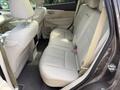 Interior of a 2016 Nissan Murano showing the back seats with light gray leather upholstery and headrests