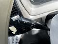 A close-up of the windshield wiper control lever in a 2004 Toyota Toyoace showing different wiper settings