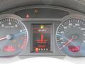 Dashboard of a 2006 Audi A6 showing various gauges including speedometer, tachometer, fuel level, and a warning light for coolant temperature