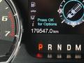 Dashboard display of a 2014 Ford F-150 showing odometer reading of 179547 km with options to press OK for further details