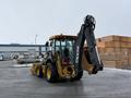 2011 John Deere 310SJ 4x4 wheel loader with an extended hoe and a 4 in 1 bucket facing away from the camera