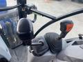 Control levers and joystick inside a 2016 New Holland T475 tractor cab with ergonomic design for operating machinery and equipment
