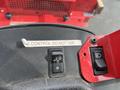 Close-up of the control panel of a 2014 John Deere 1585 Terrain Cut featuring a switch and a warning label that says CONTROL DO NOT USE