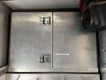 A 2006 GMC C5000 with a silver metal exterior and various compartments including locks and handles