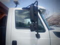 Close-up of the side mirror and window of a 2016 International WorkStar 7500 truck showing a black mirror mount and a clear glass window