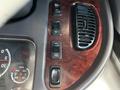 Interior dashboard controls of a 2016 Freightliner M2 106 featuring buttons for various functions and an air vent in a wood grain panel