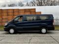 A dark blue 2020 Ford Transit van positioned sideways showing its side profile with windows and wheels visible