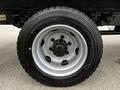 Close-up of a Michelin tire mounted on a silver wheel with black lug nuts and the size 225/70R19.5 clearly visible