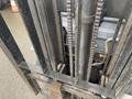 A 2011 Toyota 028FG15 forklift showing the lift mechanism including chains and hydraulic components